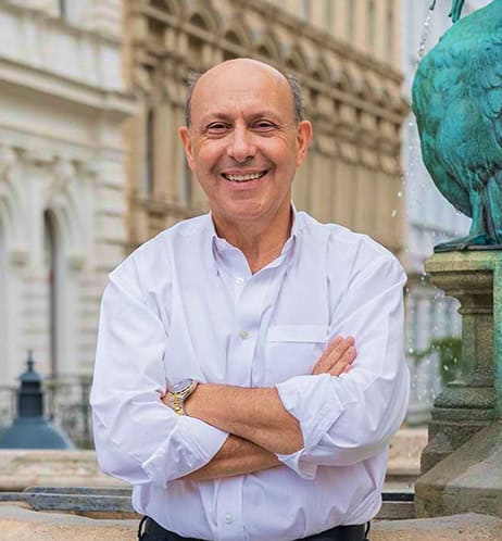Freundlicher Arzt Dr. Turkof vor Wasserbrunnen bei Centrum Aestheticum Wien.